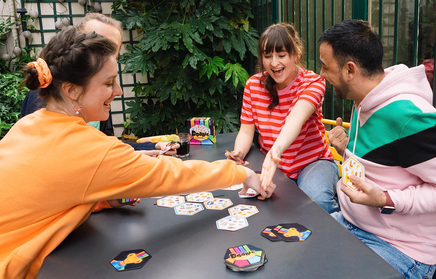 Jugadores disfrutando una partida del juego de mesa Dobble Connect en equipos